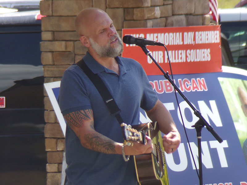 County Council candidate Benton Blount sings and plays guitar Monday at Trailblazer Park..