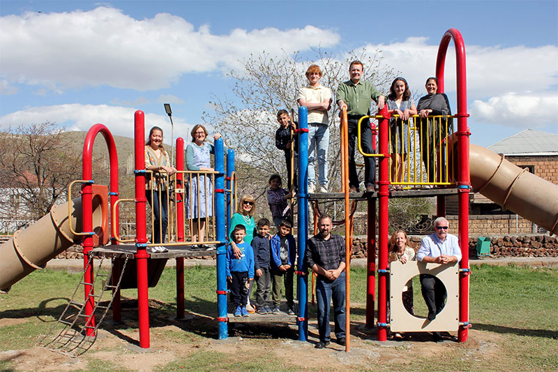 The Armenian Relief Mission team and the completed playground with some of the local children from Ujan Armenia