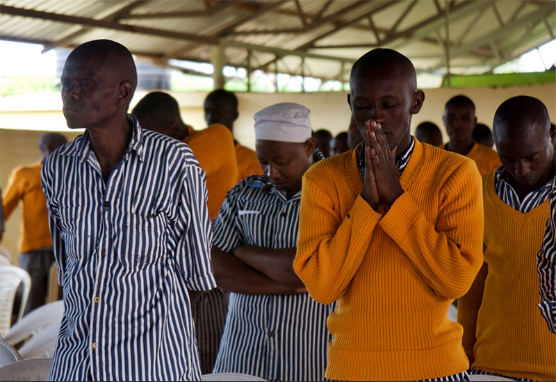 The Prisoners Journey graduates in Kenya gather in prayer during a graduation ceremony