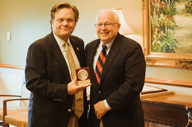 NGU Board Chair Mike Hamlet (right) was honored by the Board of Trustees with the Betty Jo Craft Service Award. The award, presented by NGU President Dr. Gene C. Fant, Jr., (left) was established in 2019, and is voted on by and presented to a board member that has made a long-term, consistent commitment that is extraordinary and has had a visible impact or result directly related to support the mission of NGU. Craft passed away on November 25, 2021.