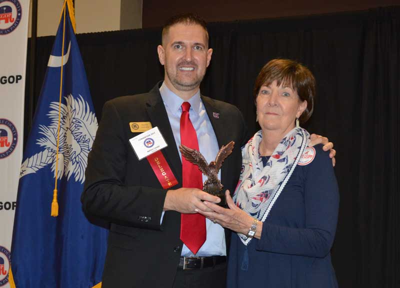 Gayle Stanley receives a Special Service Award from GOP Chairman Leupp. - Photo by Gilbert Scales