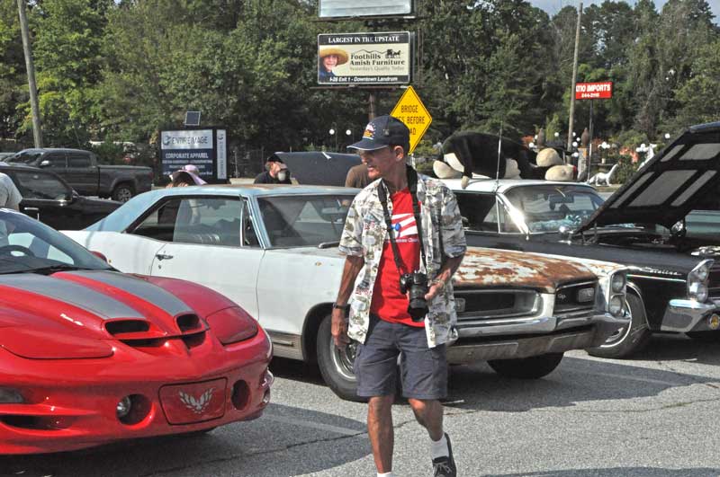 Post 214 Adjutant Tony Dunn searching for another automobile to be photographed.