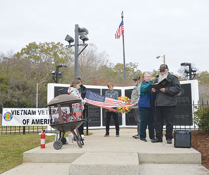 Vietnam Veterans of America perform a  Flag Retirement Ceremony on Veterans Day at  Cleveland Park’s Vietnam Veteran Memorial with  the help of those attending.