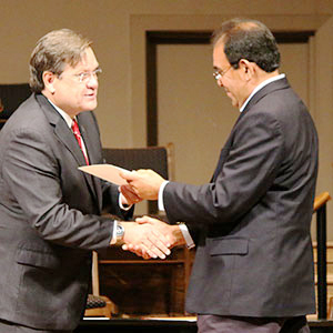 L to R: NGU President Dr. Gene C. Fant, Jr. awards a certificate to a graduate at the IBH graduation ceremony held at Edwards Road Baptist Church in Greenville on Saturday, August 11.