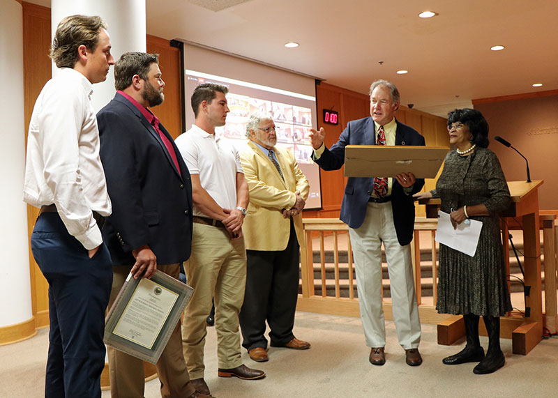 South Carolina State Representative Mike Burns (second from right) is joined by Rep. Leola Robinson (right) as he reads a resolution from the State House of Representatives honoring NGU Baseball for the team’s 2022 NCAA Division II National Championship. The team was represented by (from left) pitcher Noah Takac, Head Coach Landon Powell, and catcher John Michael Faile, as Councilman Joe Dill (third from right) looks on.