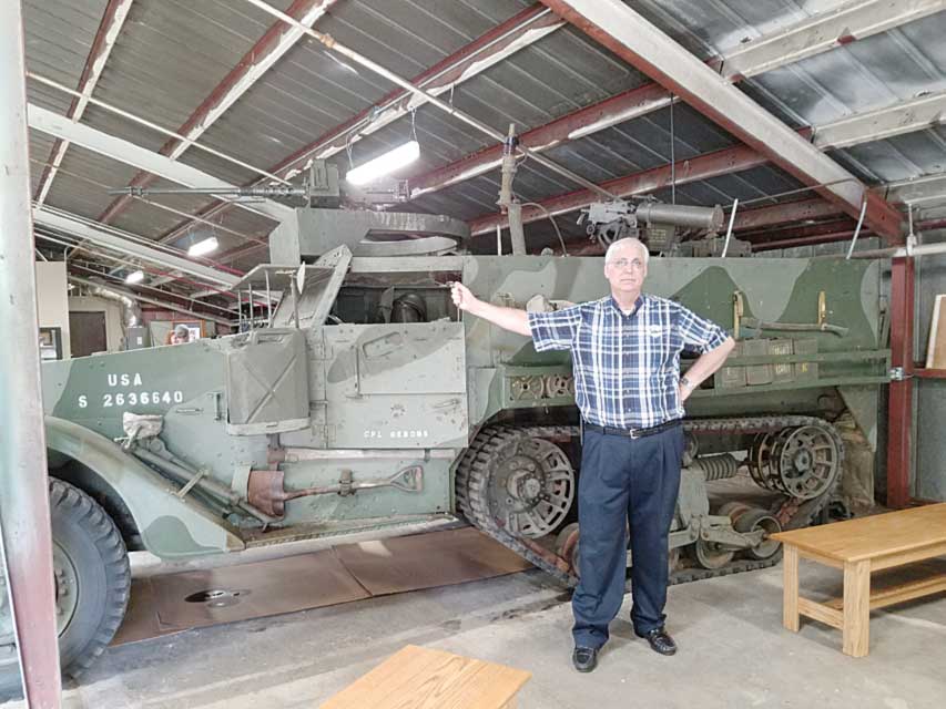 Ray Sheen stands by a Korean War half-track, the type his father George Sheen, commanded in the war. - Photo by Holly Sheen 