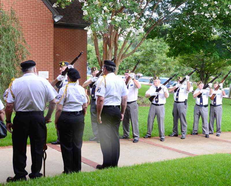 American Legion Post 120 Honor Guard fires a rifle salute in honor of US Air Force Vietnam Veteran Frederick Scales as Vietnam veterans from Vietnam Veterans of America Greenville Chapter 523 observes.
