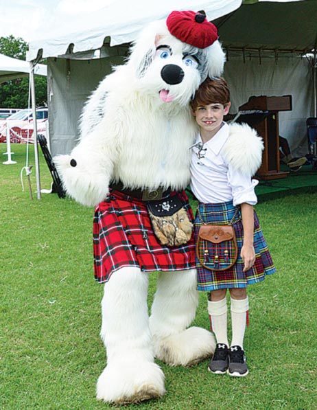 Thomas Anderson, age 10, made friends with Shaemus McDuff (Dog) at this years Highland Games at Furman University. (Photo by Tony Dunn)